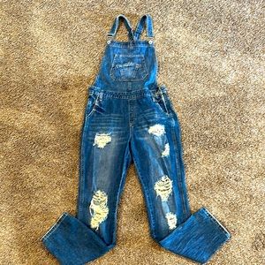 Size S distressed over all. Thick material. Boutique bought. Fits size 3-5